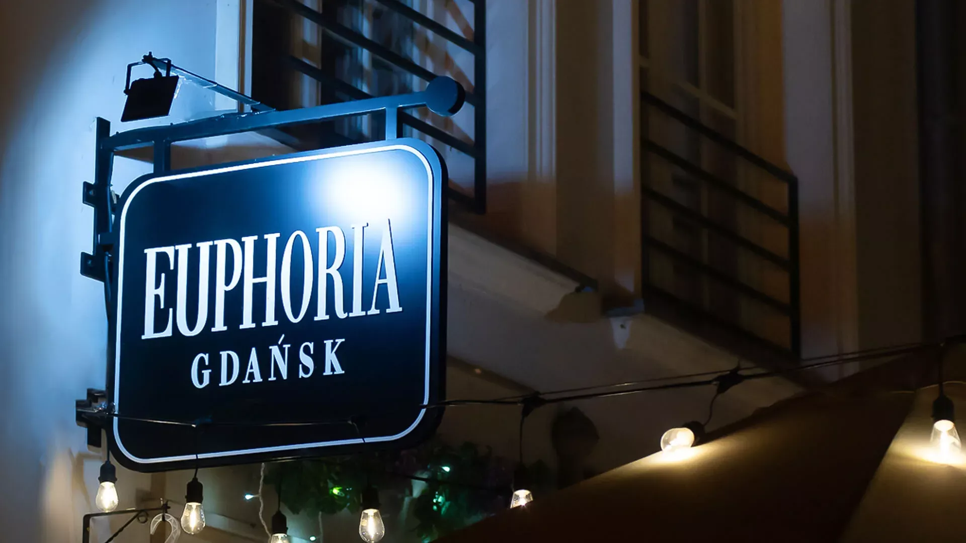Euphoria Gdansk - Perpendicular semaphore, double-sided in black with white letters at night